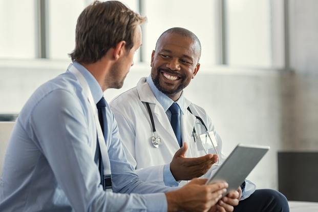 Important Disclaimer for Fitness, Workout & Nutrition Content | FitnessNexa multiethnic specialist doctors discussing case picture id1189302612